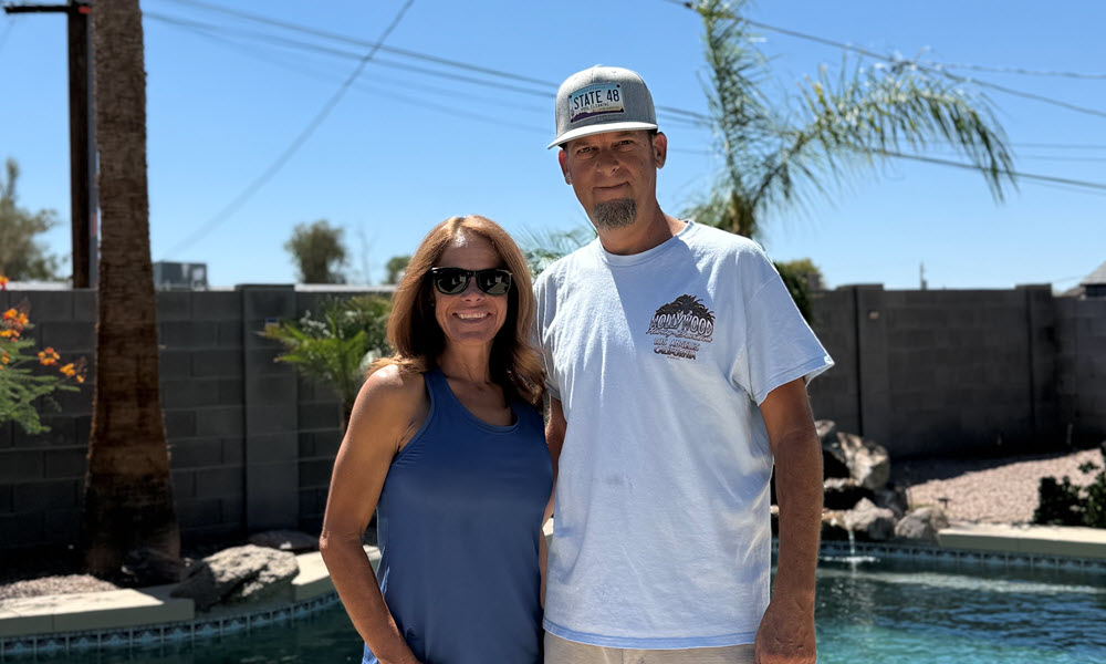 Sean Kemp owner of State 48 Pool Cleaning with wife at poolside.